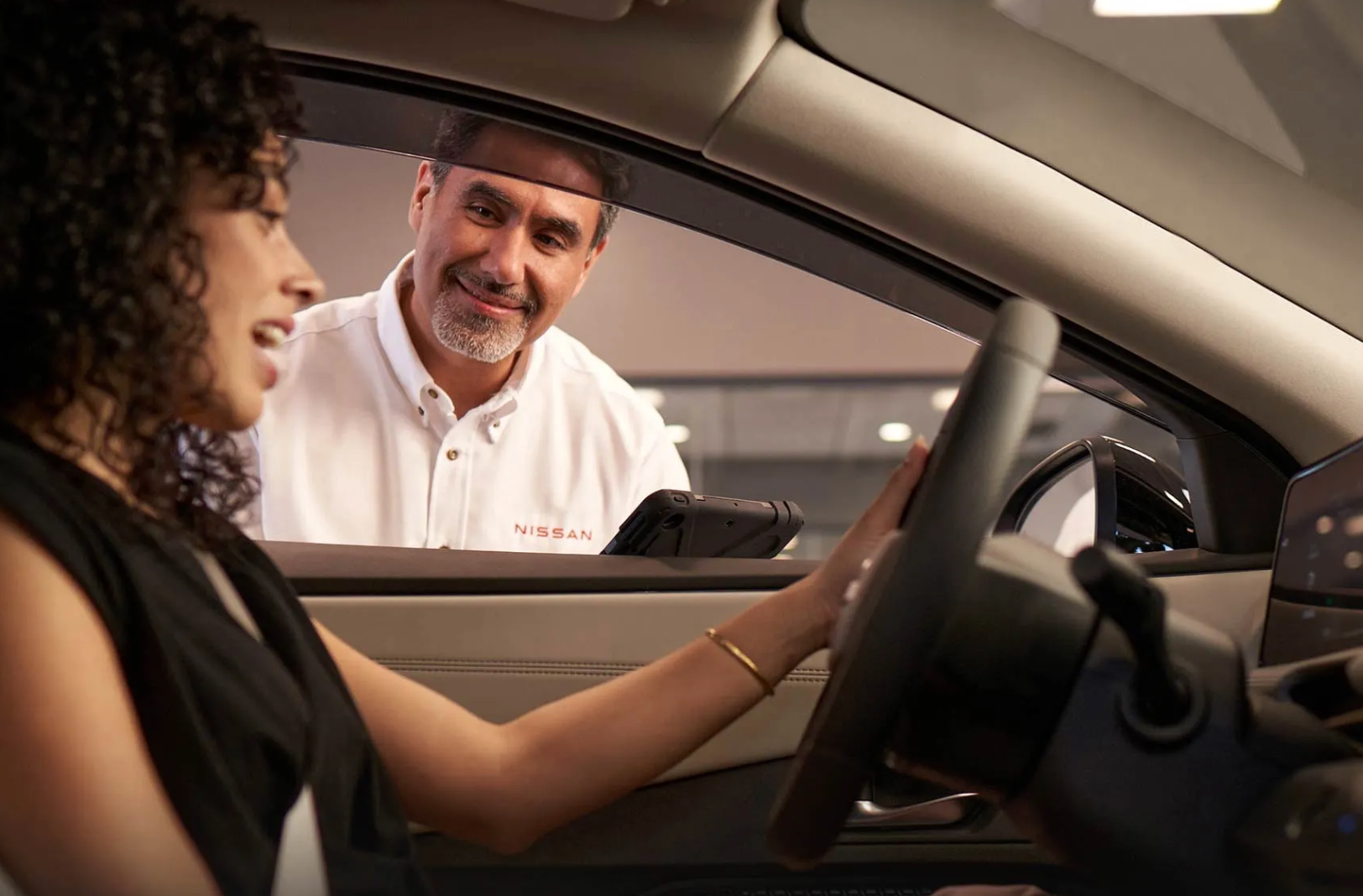 Woman getting her vehicle serviced at a Nissan service center